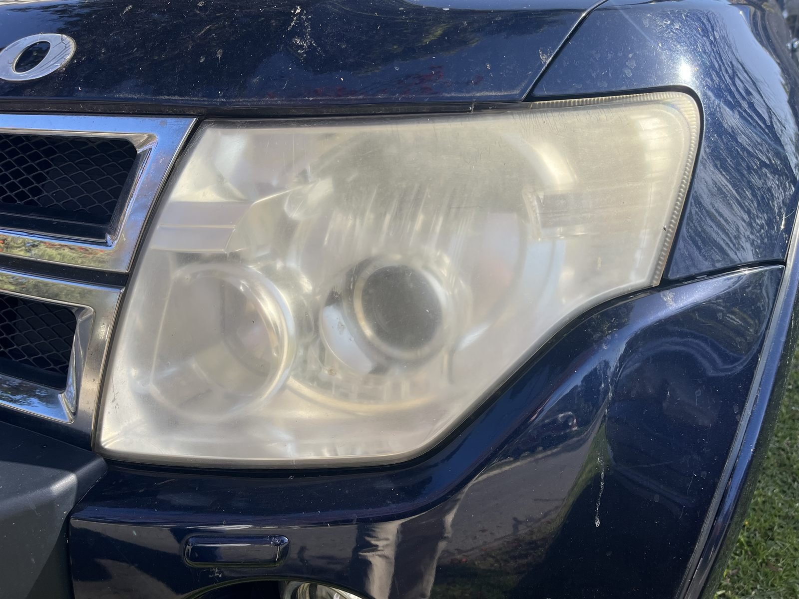 Mitsubishi Pajero headlight before restoration — yellowed and cloudy